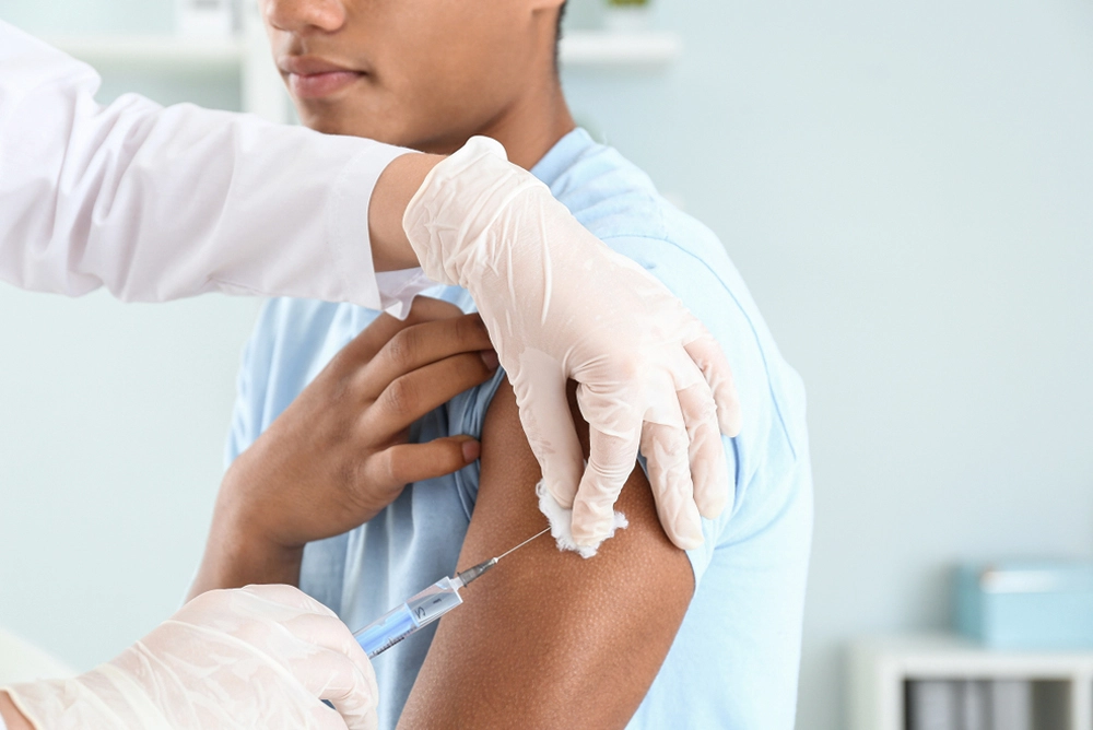 Pharmacist giving a man a vaccine