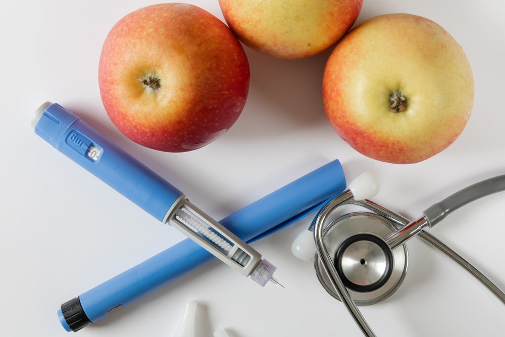 semaglutide injection pen with apples and stethoscope
